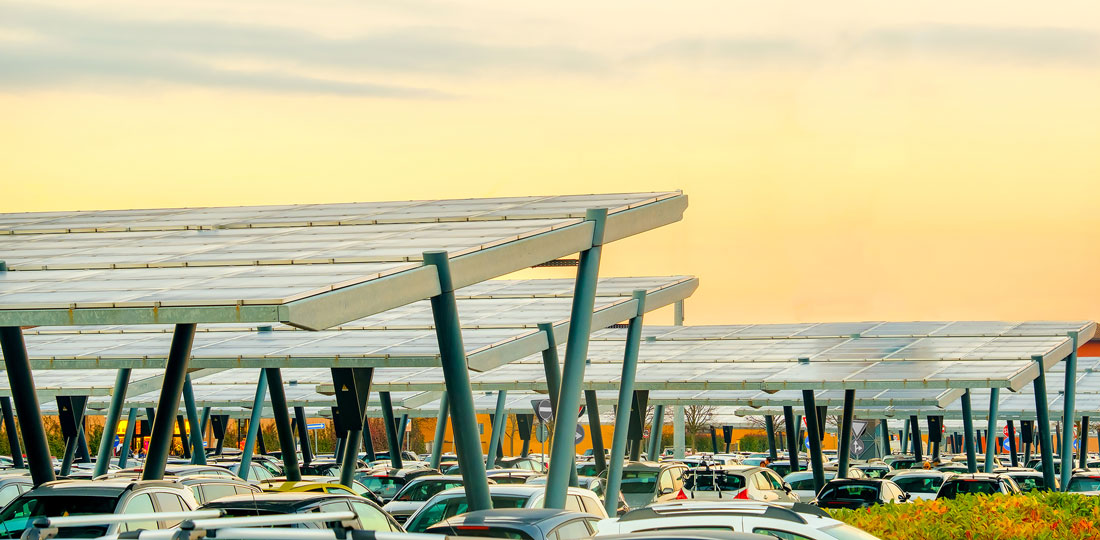 Solar panel canopies covering a large surface parking lot.