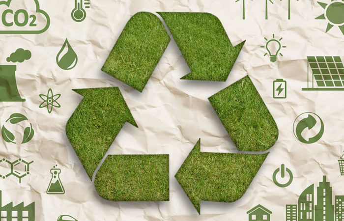 A recycling symbol made of grass on a brown paper background. Illustration.